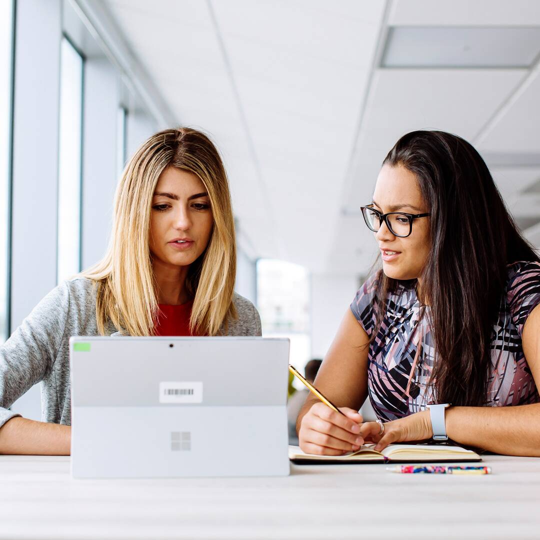 two women using a tablet