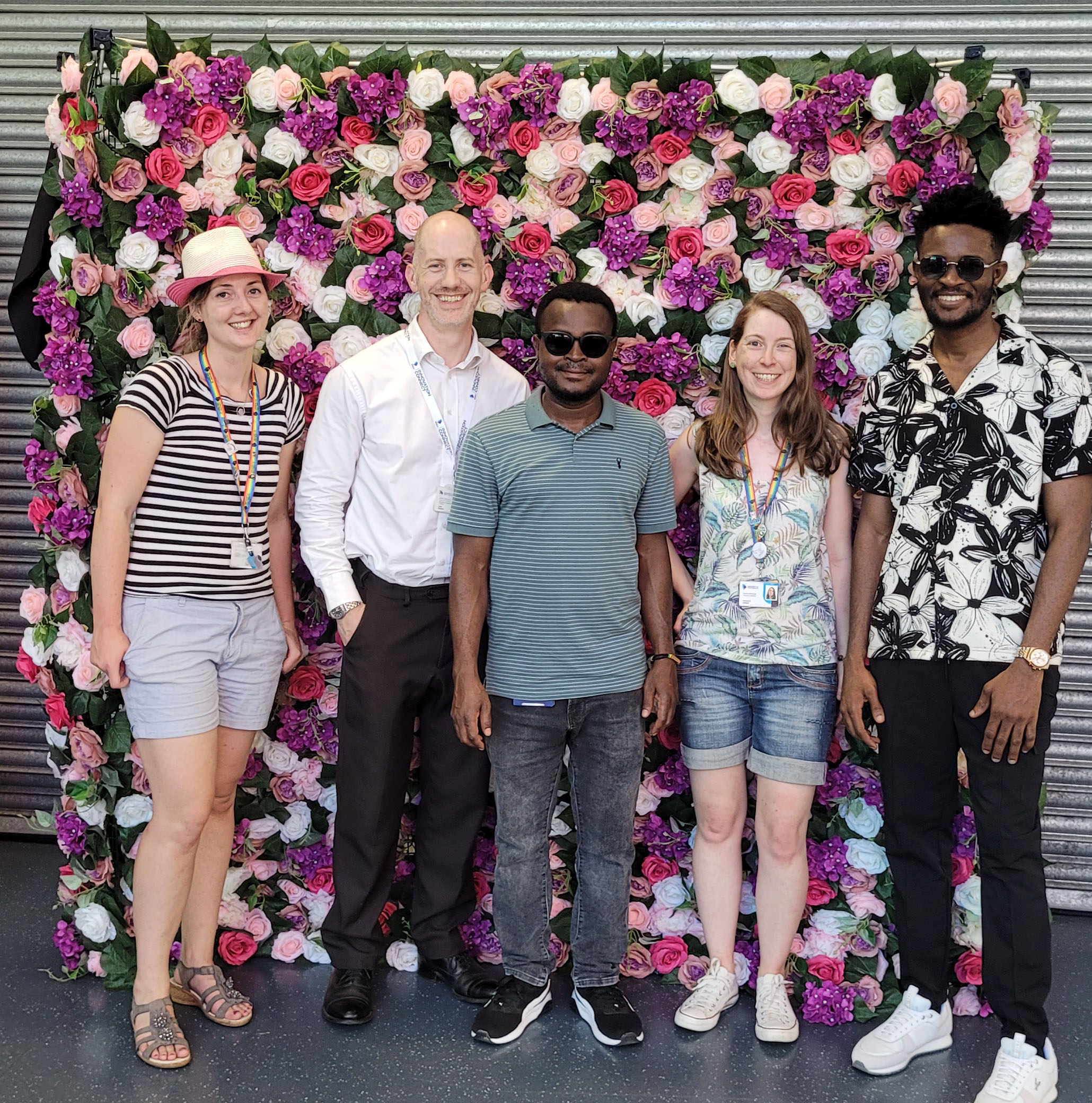 team in front of flower wall