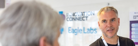 two people with Barclays Eagle Labs logo in background